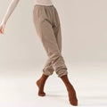 “Coffee-colored fitted trousers, classical dance costume.”