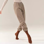 “Coffee-colored fitted trousers, classical dance costume.”