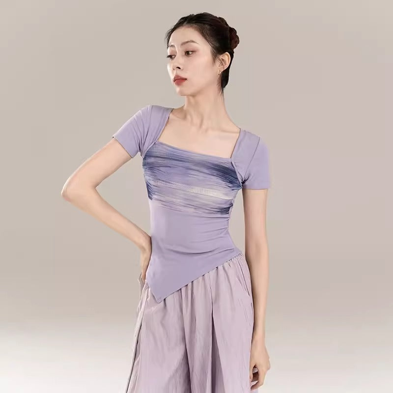 “Purple short-sleeved cropped top with deep classical dance attire.”